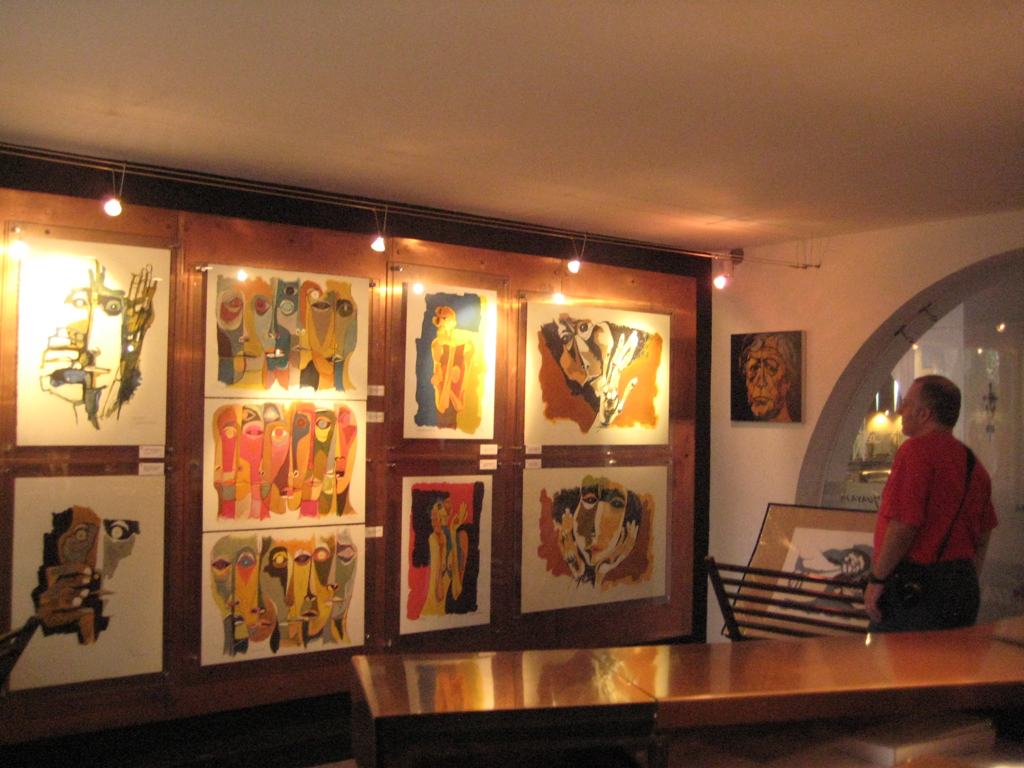 Photo of Tony Zeoli looking at the original artworks for sale in the shop at Casa De Guayasamin