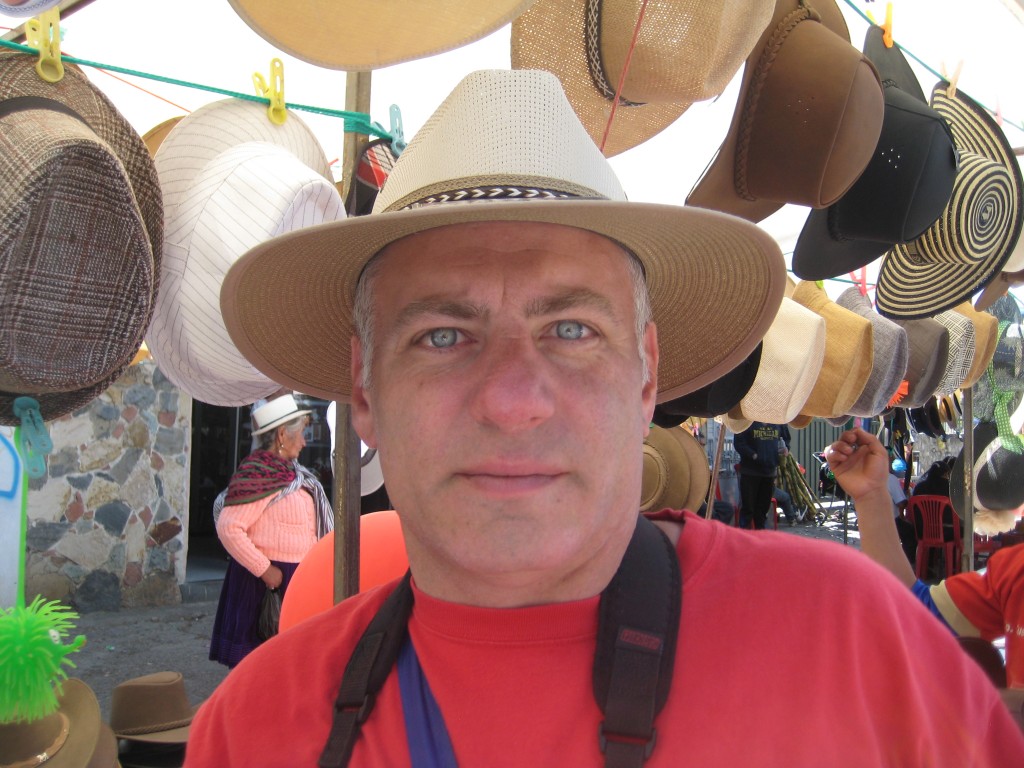 Tony Zeoli photo In Cuenca trying on panama hats at the Passe de Niño parade.